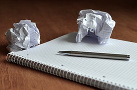 pen and crumpled rough drafts